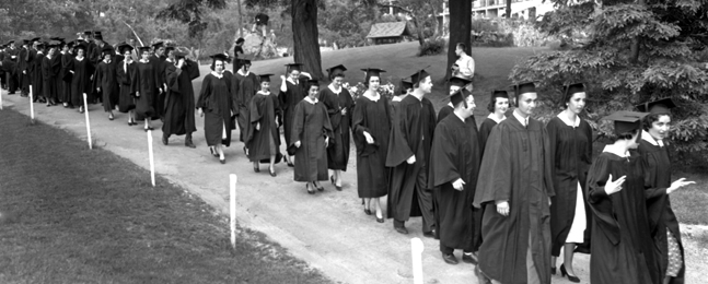 A line of 1956 grads walk down a path on the Brandeis campus